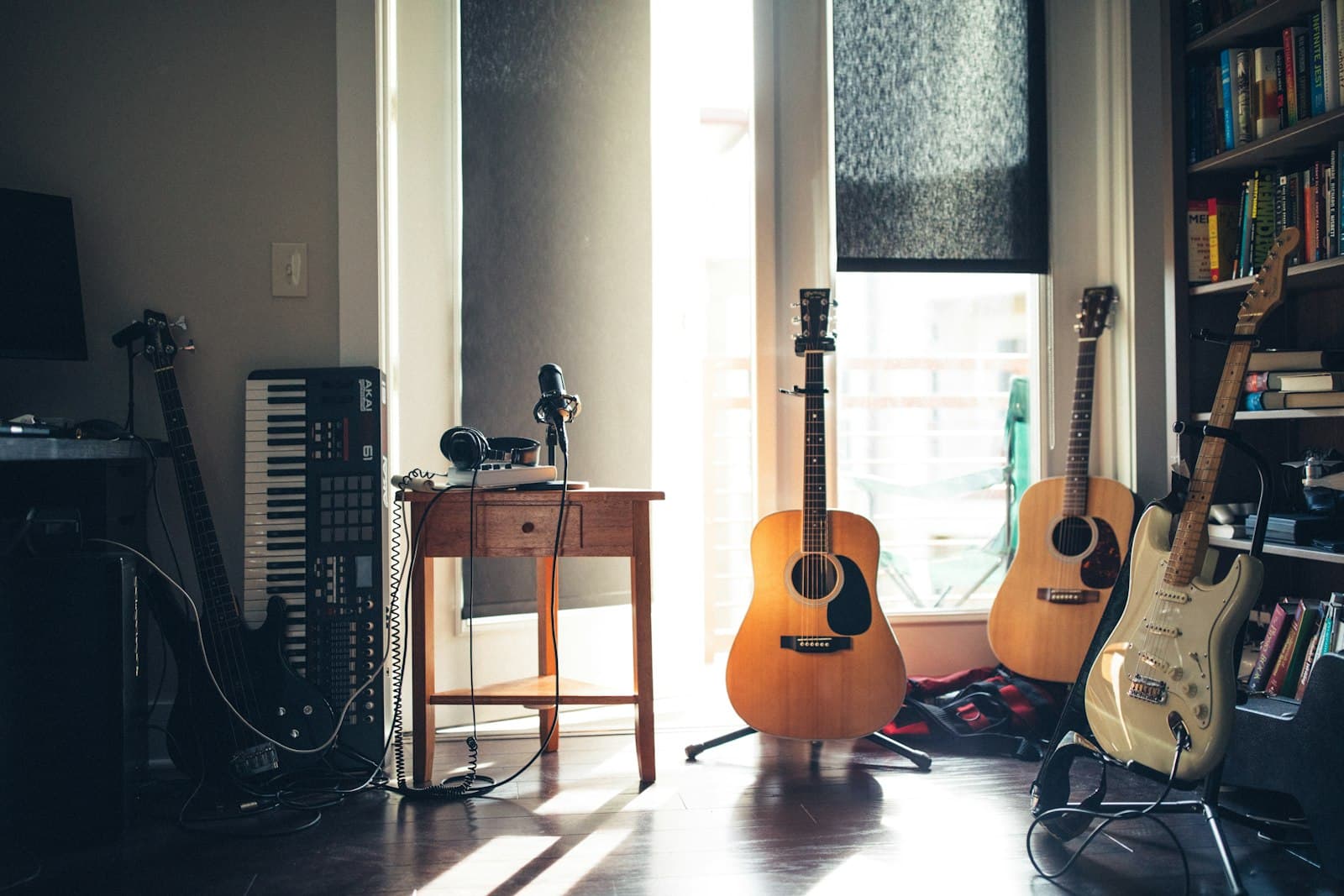 A home studio with guitars, a keyboard and a microphone